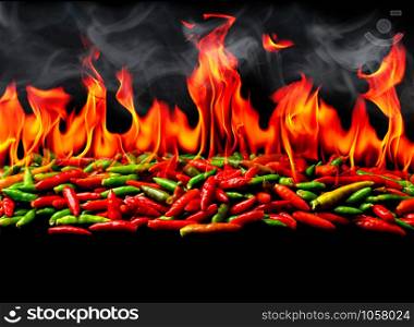 Group of Red Hot chili pepper on fire and smoke at black background
