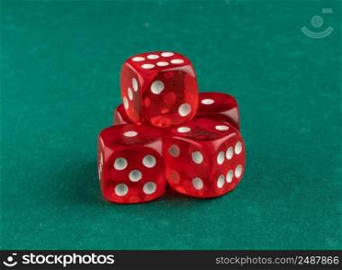 group of red playing dice on a green background, isolated. playing dice, close-up