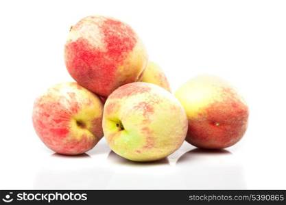 Group of ripe peaches isolated on white