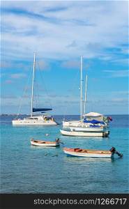 Group of sailboats floating on blue sea water at coast of Bonaire