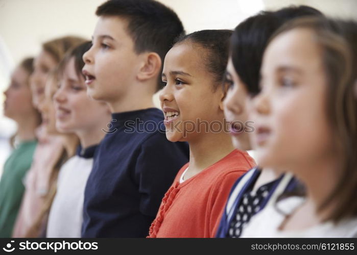 Group Of School Children Singing In Choir Together