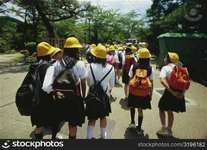 Group of schoolgirls walking on the road, Kyoto Prefecture, Japan
