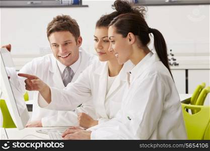 Group Of Scientists Checking Laboratory Results On Computer