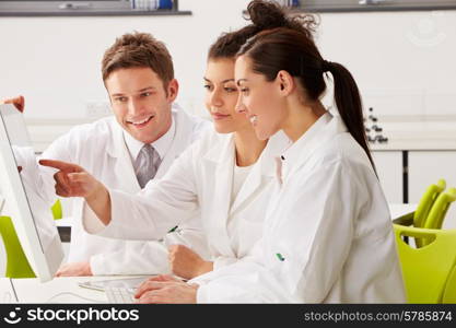 Group Of Scientists Checking Laboratory Results On Computer