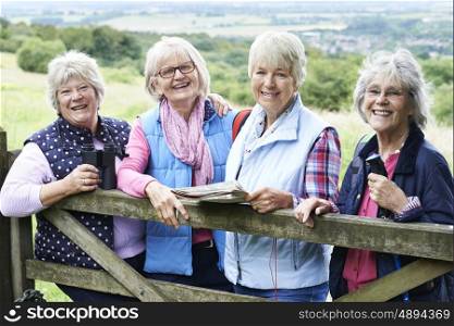 Group Of Senior Female Friends Hiking In Countryside