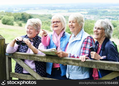 Group Of Senior Female Friends Hiking In Countryside