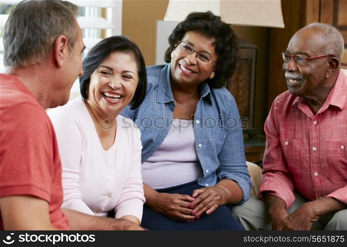 Group Of Senior Friends Chatting At Home Together