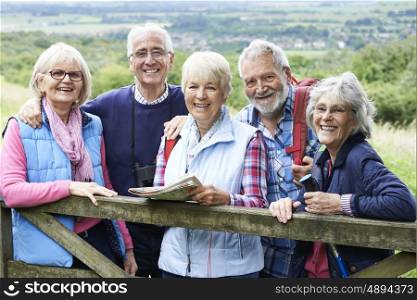 Group Of Senior Friends Hiking In Countryside