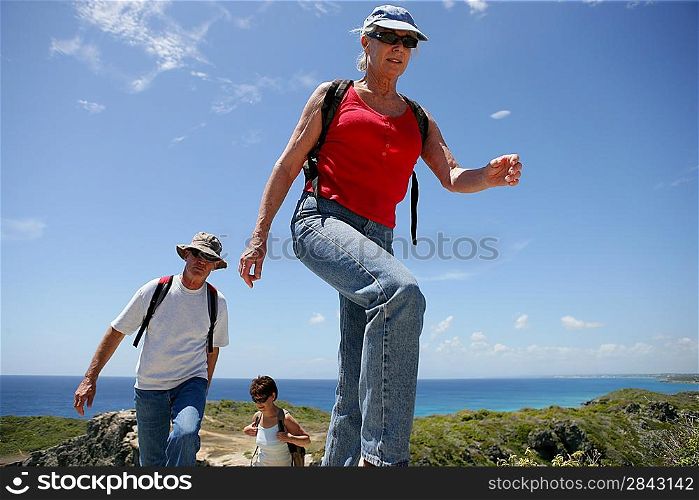 Group of senior persons hiking by a sunny day