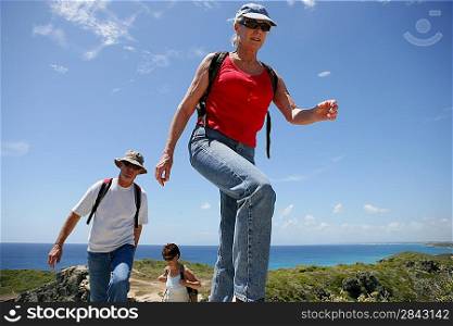 Group of senior persons hiking by a sunny day