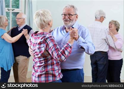 Group Of Seniors Enjoying Dancing Club Together