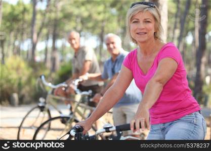 group of seniors riding bikes in the park