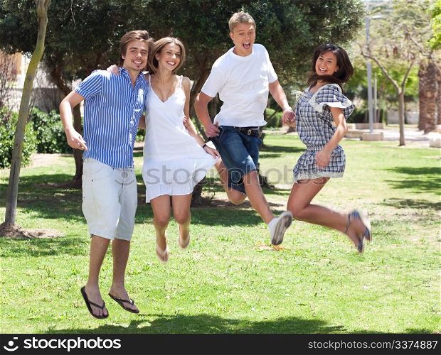 Group of six young friends having fun in the park