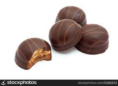 Group of small chocolate covered cakes isolated on white