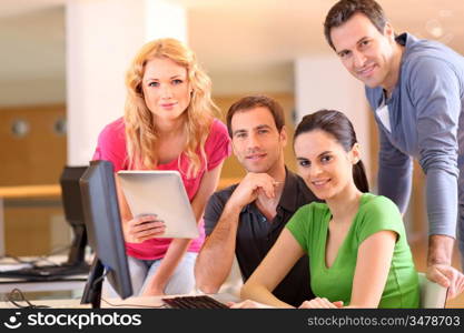 Group of smiling young people in training course