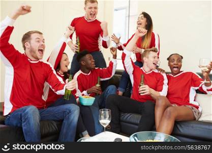 Group Of Sports Fans Watching Game On TV At Home