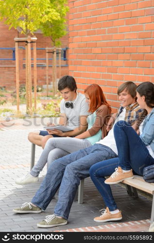 Group of students friends hanging out sitting outside college campus