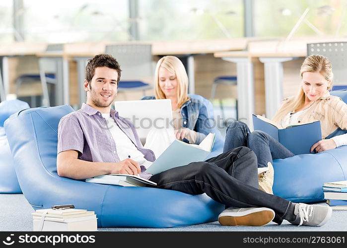 Group of students learning at high school relaxing with books