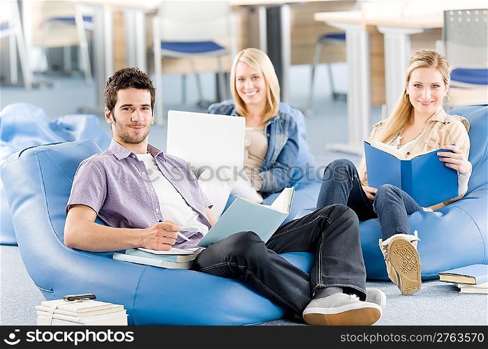 Group of students learning at high school relaxing with books