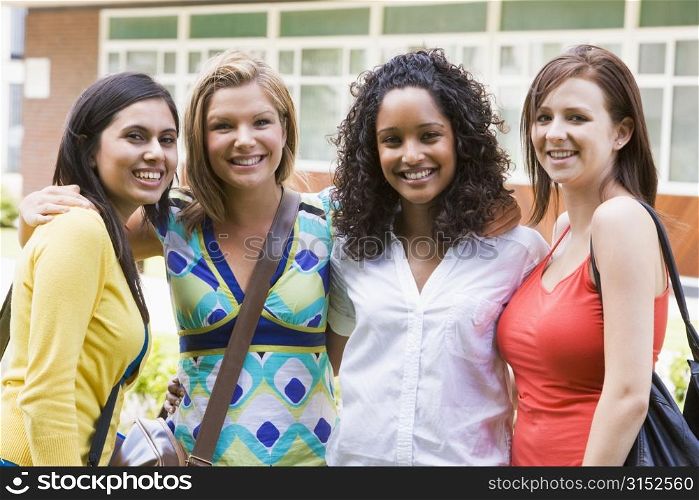 Group of students outdoors looking at camera smiling