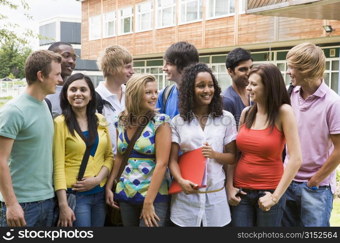 Group of students outdoors looking at camera smiling