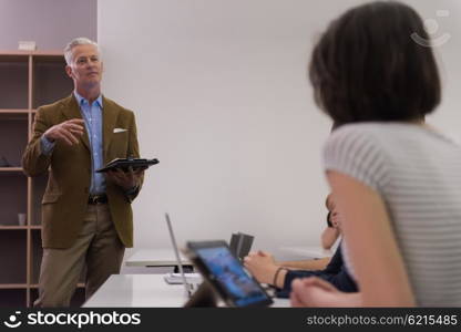 group of students study with professor in modern school classroom