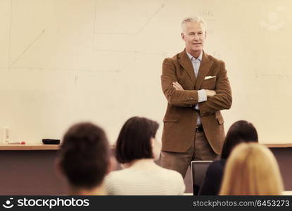 group of students study with professor in modern school classroom