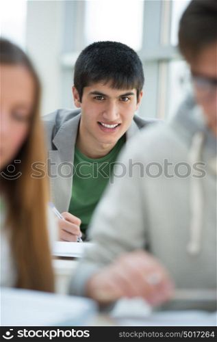 Group of students studying together in classroom