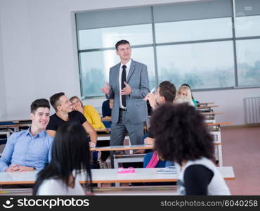 group of students with teacher in computer lab classrom learrning lessons, get help and support