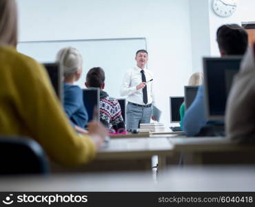 group of students with teacher in computer lab classrom learrning lessons, get help and support