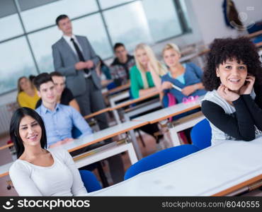 group of students with teacher in computer lab classrom learrning lessons, get help and support