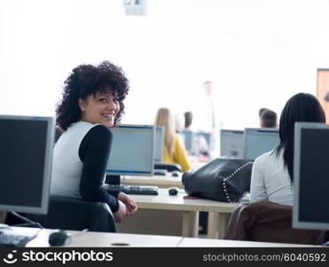 group of students with teacher in computer lab classrom learrning lessons, get help and support