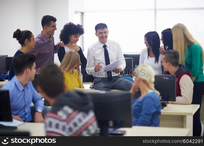 group of students with teacher in computer lab classrom learrning lessons, get help and support