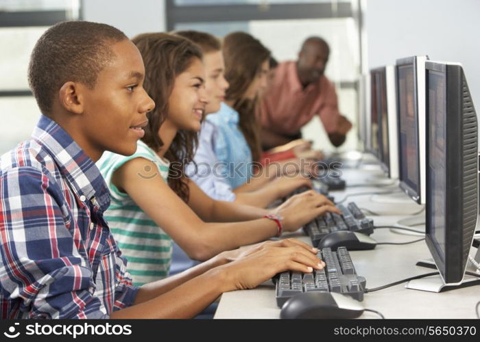 Group Of Students Working At Computers In Classroom