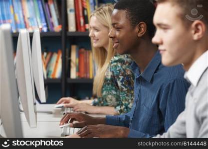 Group Of Students Working At Computers In Classroom