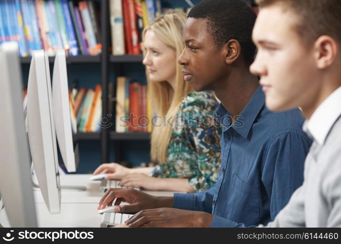 Group Of Students Working At Computers In Classroom