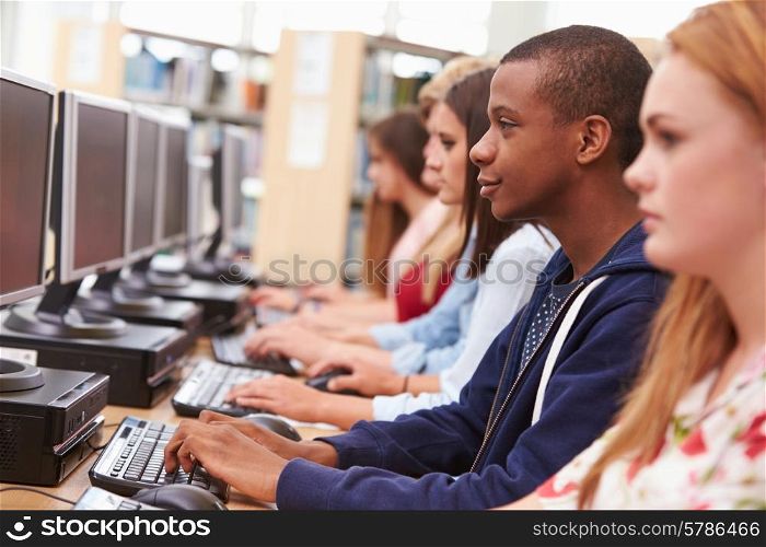 Group Of Students Working At Computers In Library