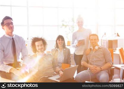Group of successfull business group meeting in the at work with sun flare