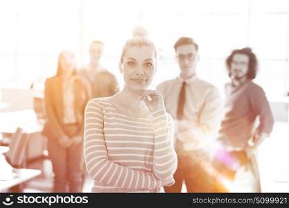 Group of successfull business group meeting in the at work with sun flare