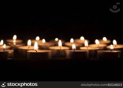 Group of tea candles on a black background