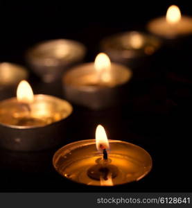 Group of tea candles on a black background