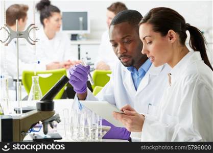 Group Of Technicians Working In Laboratory