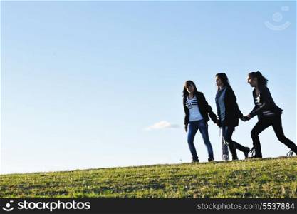 group of teen people woman have fun outdoor with blue sky in background