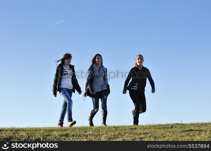 group of teen people woman have fun outdoor with blue sky in background