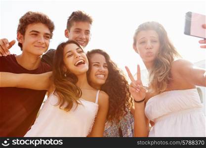 Group Of Teenage Friends Dancing And Taking Selfie