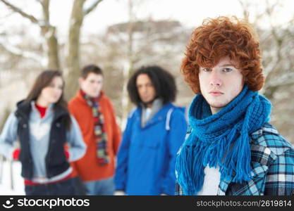 Group Of Teenage Friends Having Fun In Snowy Landscape Wearing Ski Clothing