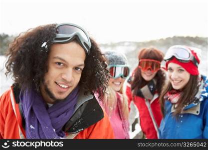 Group Of Teenage Friends Having Fun In Snowy Landscape Wearing Ski Clothing