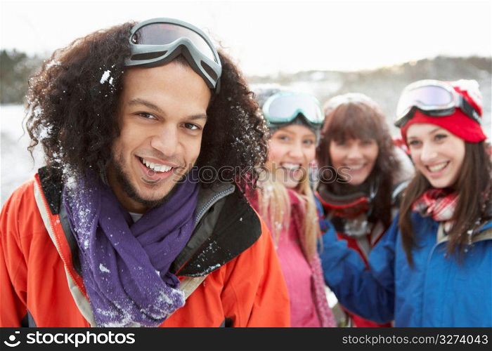 Group Of Teenage Friends Having Fun In Snowy Landscape Wearing Ski Clothing