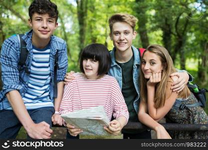 Group Of Teenage Friends Hiking In Countryside Together