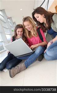 Group of teenage girls at school with laptop computer